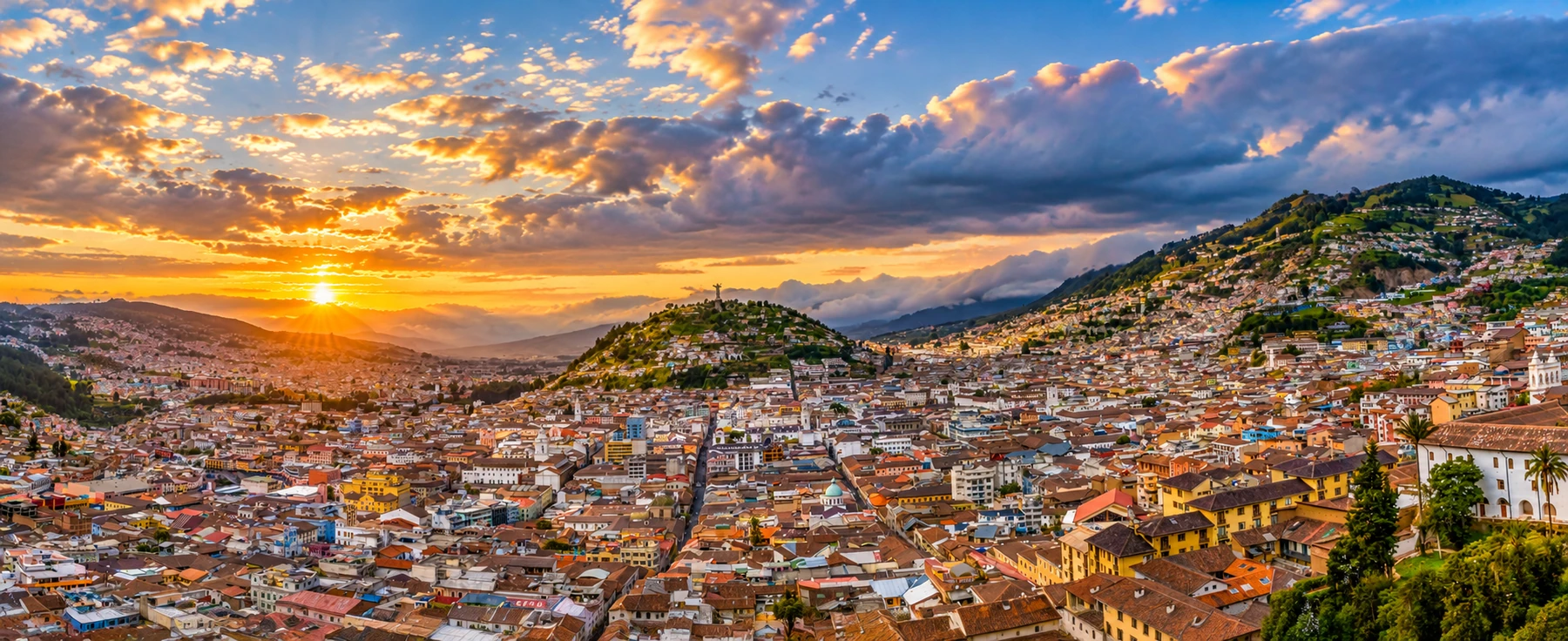 A city made of light. A sweeping sunset view over the dense cityscape and hills of Quito, Ecuador.
